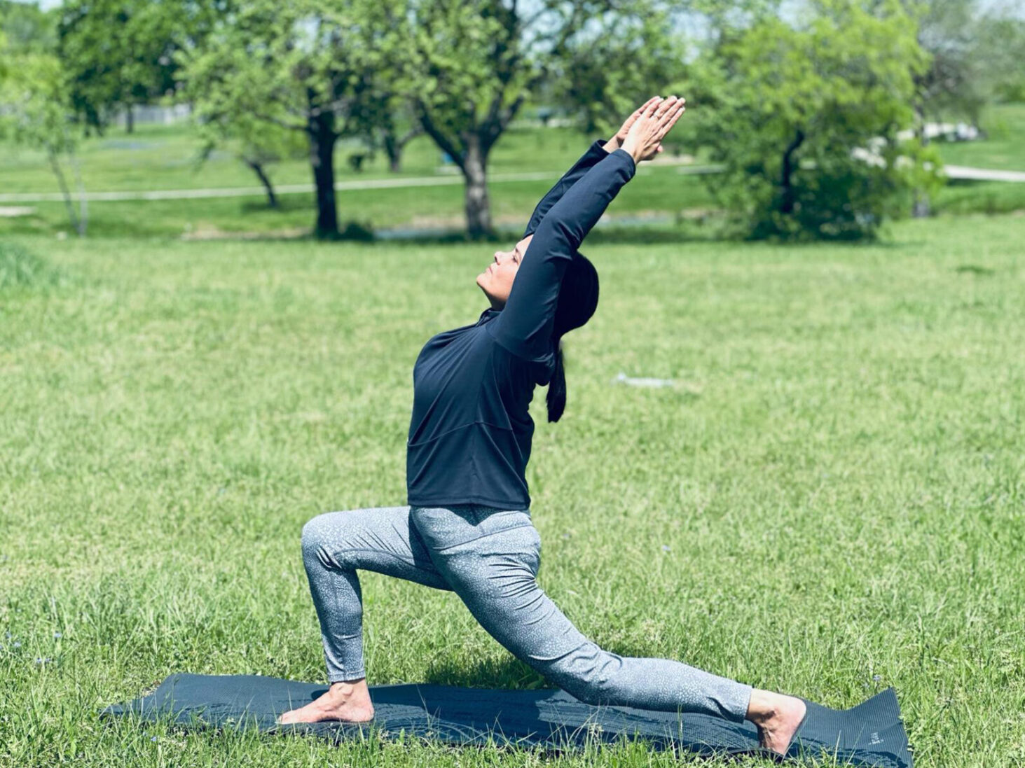 Sunita practicing yoga in a peaceful outdoor setting